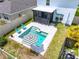 Inviting pool area with a black-and-white striped umbrella and blue chairs, perfect for relaxation and enjoyment at 3027 Great Abaco Way, Bradenton, FL 34208
