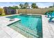 Inviting pool with cascading fountains and colorful accents, perfect for backyard relaxation at 3027 Great Abaco Way, Bradenton, FL 34208