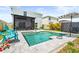 Sparkling in-ground pool surrounded by a patio, lush landscaping and seating at 3027 Great Abaco Way, Bradenton, FL 34208