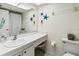 Bathroom featuring single sink vanity and starfish decorations at 305 30Th Ave W # A104, Bradenton, FL 34205