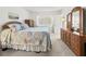 Bedroom featuring a bed with sea-themed bedding, a dresser, and a bright window at 305 30Th Ave W # A104, Bradenton, FL 34205