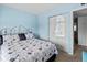 Cozy bedroom with blue walls and patterned bedspread at 305 30Th Ave W # A104, Bradenton, FL 34205