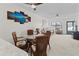 Bright dining area with glass table, seating for four, and a view of the open-concept living space at 305 30Th Ave W # A104, Bradenton, FL 34205
