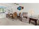 Dining area featuring a round glass table, seating for four, and open access to the kitchen at 305 30Th Ave W # A104, Bradenton, FL 34205