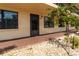 Condo entrance showcasing a welcoming walkway with decorative stone landscaping and a small tree at 305 30Th Ave W # A104, Bradenton, FL 34205
