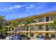 Condo building featuring multiple floors with balconies and tropical landscaping at 305 30Th Ave W # A104, Bradenton, FL 34205