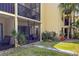 Exterior view of a unit with a screened-in patio and landscaped lawn at 305 30Th Ave W # A104, Bradenton, FL 34205