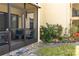 View of the screen lanai, and lush garden, from the outside at 305 30Th Ave W # A104, Bradenton, FL 34205