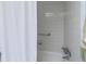 Bright white tiled shower with chrome fixtures at 305 30Th Ave W # A104, Bradenton, FL 34205