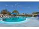 Community swimming pool with lounge chairs and clear blue water under sunny skies at 305 30Th Ave W # A104, Bradenton, FL 34205
