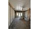 A partially renovated room with exposed framing, ceiling fan, and plenty of natural light at 305 59Th St, Holmes Beach, FL 34217