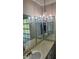 Unique bathroom vanity with gold wallpaper, lots of mirrors, and vintage-style fixtures at 3052 51St St, Sarasota, FL 34234