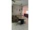 A view of the dining room with a bar and access to the living room with decorative lighting at 3052 51St St, Sarasota, FL 34234