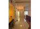 View of the foyer with yellow walls, decorative lighting, tile floors, and large front door at 3052 51St St, Sarasota, FL 34234