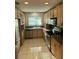 A well-lit kitchen features wooden cabinets, stainless steel appliances, and granite countertops at 3052 51St St, Sarasota, FL 34234
