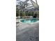 Sparkling pool with a screened-in enclosure and patio area for outdoor relaxation and enjoyment at 3052 51St St, Sarasota, FL 34234