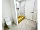 Bathroom featuring modern toilet, gold fixtures, and unique gold bathtub with shower at 3320 Riviera Dr, Sarasota, FL 34232