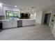 Bright, updated kitchen boasts white cabinets, stainless appliances, and views of the pool at 3320 Riviera Dr, Sarasota, FL 34232