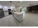 Open-concept kitchen with stainless steel appliances, a large island, and a view to the pool at 3320 Riviera Dr, Sarasota, FL 34232