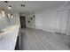 Spacious open-concept area with modern flooring, white walls, and ample natural light at 3320 Riviera Dr, Sarasota, FL 34232