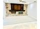 Spacious living room featuring stone fireplace, ceiling fan and modern flooring at 3320 Riviera Dr, Sarasota, FL 34232