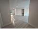 Open living room has light-colored wood-look flooring and neutral paint palette at 3320 Riviera Dr, Sarasota, FL 34232