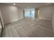 Large, open living area with light wood flooring and neutral paint at 3320 Riviera Dr, Sarasota, FL 34232