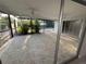 Enclosed patio with stone floors, tropical plants, and access to the pool area at 3320 Riviera Dr, Sarasota, FL 34232