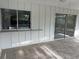Enclosed patio featuring stamped concrete flooring, sliding windows, and backyard views at 3320 Riviera Dr, Sarasota, FL 34232