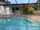 Inviting pool with brick surround, step-in entry, and lush tropical landscaping at 3320 Riviera Dr, Sarasota, FL 34232