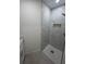 Modern walk-in shower with marble-look tile, bronze fixtures, and a built-in niche at 3320 Riviera Dr, Sarasota, FL 34232