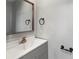 Simple bathroom featuring a sink, modern hardware, and a large mirror at 3333 Ramblewood Pl, Sarasota, FL 34237