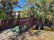 Charming wooden bridge with palm trees at 3333 Ramblewood Pl, Sarasota, FL 34237