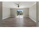 Bright, airy living room featuring wood floors, a ceiling fan, and sliding glass doors to an outdoor deck at 3333 Ramblewood Pl, Sarasota, FL 34237