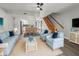 Comfortable living room with light blue furniture adjacent to an open kitchen and dining area at 3333 Ramblewood Pl, Sarasota, FL 34237