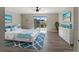 Beautiful bedroom featuring a large bed, white dresser, and a private balcony with a view at 3333 Ramblewood Pl, Sarasota, FL 34237