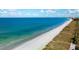 Stunning aerial view showcasing the pristine beach with clear turquoise water and soft white sand at 3802 Gulf Of Mexico Dr # A103, Longboat Key, FL 34228