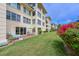 The backyard features lush grass, patio with seating, and beautiful flowers at 3802 Gulf Of Mexico Dr # A103, Longboat Key, FL 34228