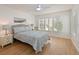 A bright bedroom featuring a ceiling fan and light-filtering shutters at 3802 Gulf Of Mexico Dr # A103, Longboat Key, FL 34228