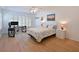Comfortable bedroom with light wooden floors and matching white bedside tables at 3802 Gulf Of Mexico Dr # A103, Longboat Key, FL 34228
