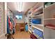 A well-organized walk-in closet with built-in shelving and ample storage space at 3802 Gulf Of Mexico Dr # A103, Longboat Key, FL 34228