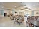 Spacious clubhouse featuring tables, chairs, a piano, and entertainment area at 3802 Gulf Of Mexico Dr # A103, Longboat Key, FL 34228