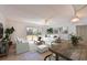 Bright living room with modern furniture and a sliding door to the outdoor area at 3802 Gulf Of Mexico Dr # A103, Longboat Key, FL 34228