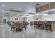 A meeting room with tables, chairs, and a bar area, perfect for community gatherings at 3802 Gulf Of Mexico Dr # A103, Longboat Key, FL 34228