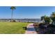 Beautiful waterfront with pier, boat parking, and lush landscaping at 3802 Gulf Of Mexico Dr # A103, Longboat Key, FL 34228