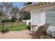 A cozy backyard patio with a table, two chairs, a fire pit, and views of the fenced yard at 415 63Rd St, Holmes Beach, FL 34217