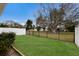 Expansive backyard featuring a well-maintained lawn and secure black metal fence for privacy and security at 415 63Rd St, Holmes Beach, FL 34217
