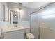A pristine bathroom features a new vanity, updated fixtures, and a glass shower enclosure at 415 63Rd St, Holmes Beach, FL 34217