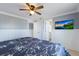 A calming bedroom with paneled walls, ceiling fan, and access to the en suite bathroom at 415 63Rd St, Holmes Beach, FL 34217