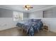 A cozy bedroom with paneled walls, a ceiling fan, and a window with shutters at 415 63Rd St, Holmes Beach, FL 34217